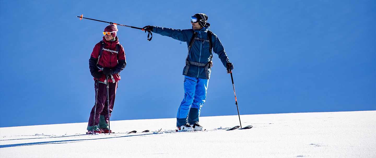 A couple on the top of a snowy mountain 