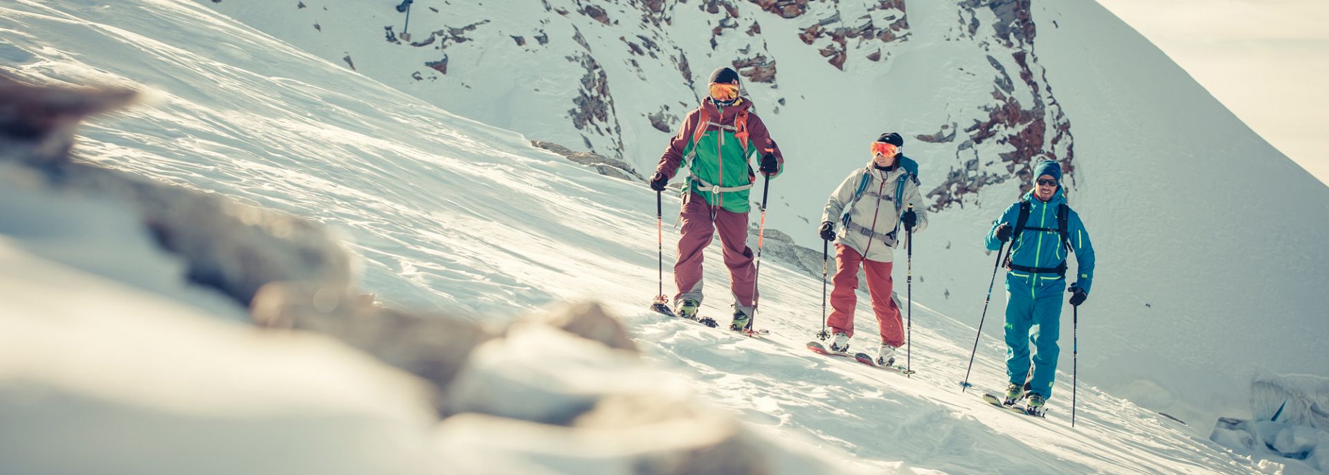 A group of skiiers going up a mountain