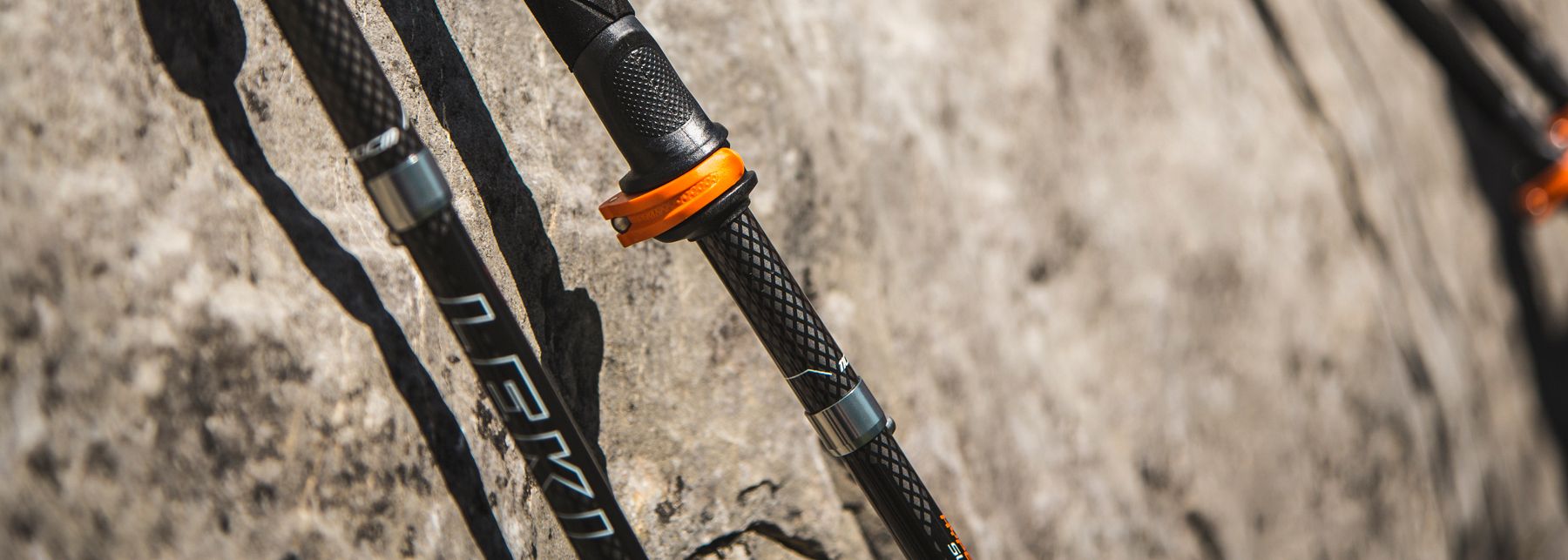 A leki pole leaning on a boulder