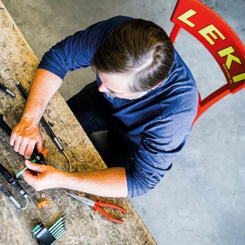 A Leki technician repairing a product